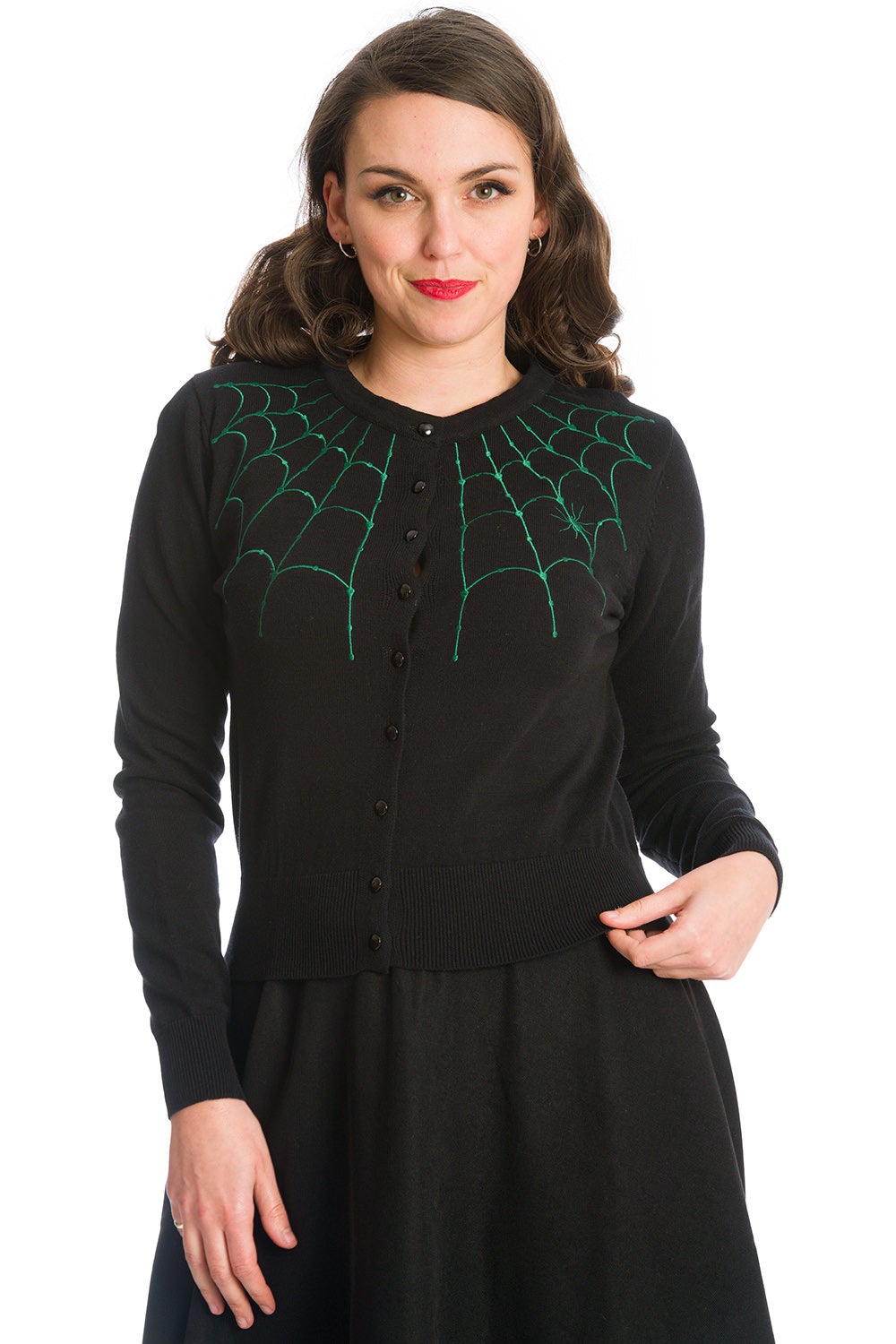 Model in black button up cardigan with green spider web shoulder details