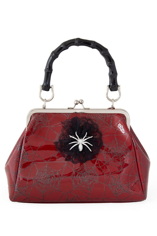 Red patent handbag with spider web print and spider detail