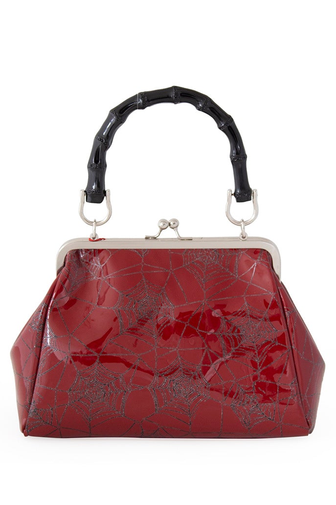 Red patent handbag with spider web print and spider detail