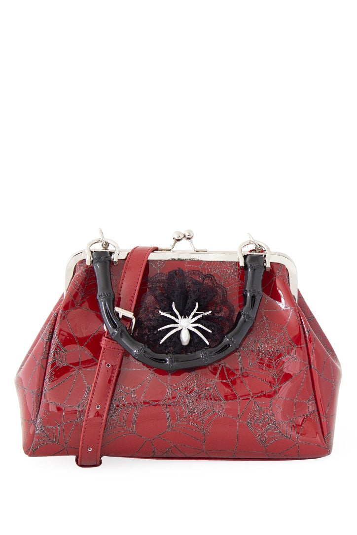 Red patent handbag with spider web print and spider detail