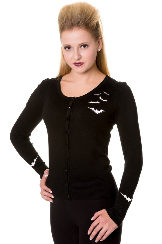 Model wearing black button up cardigan with white bat details on one side of the chest and sleeves.