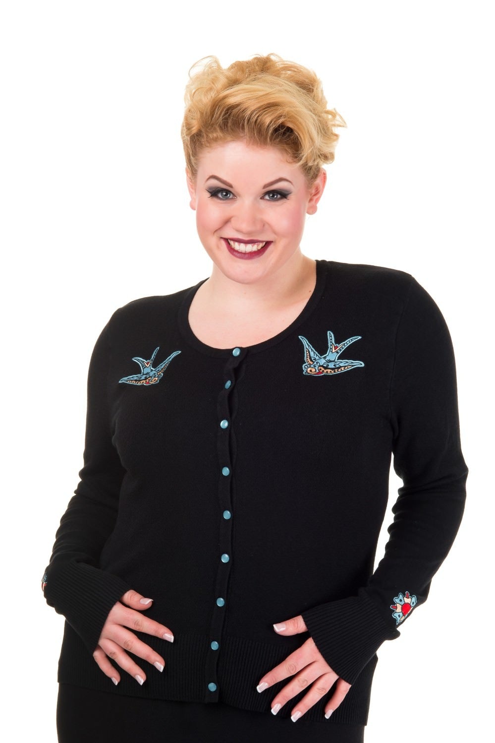 Model wearing black button up cardigan with blue buttons and blue swallow chest pieces.
