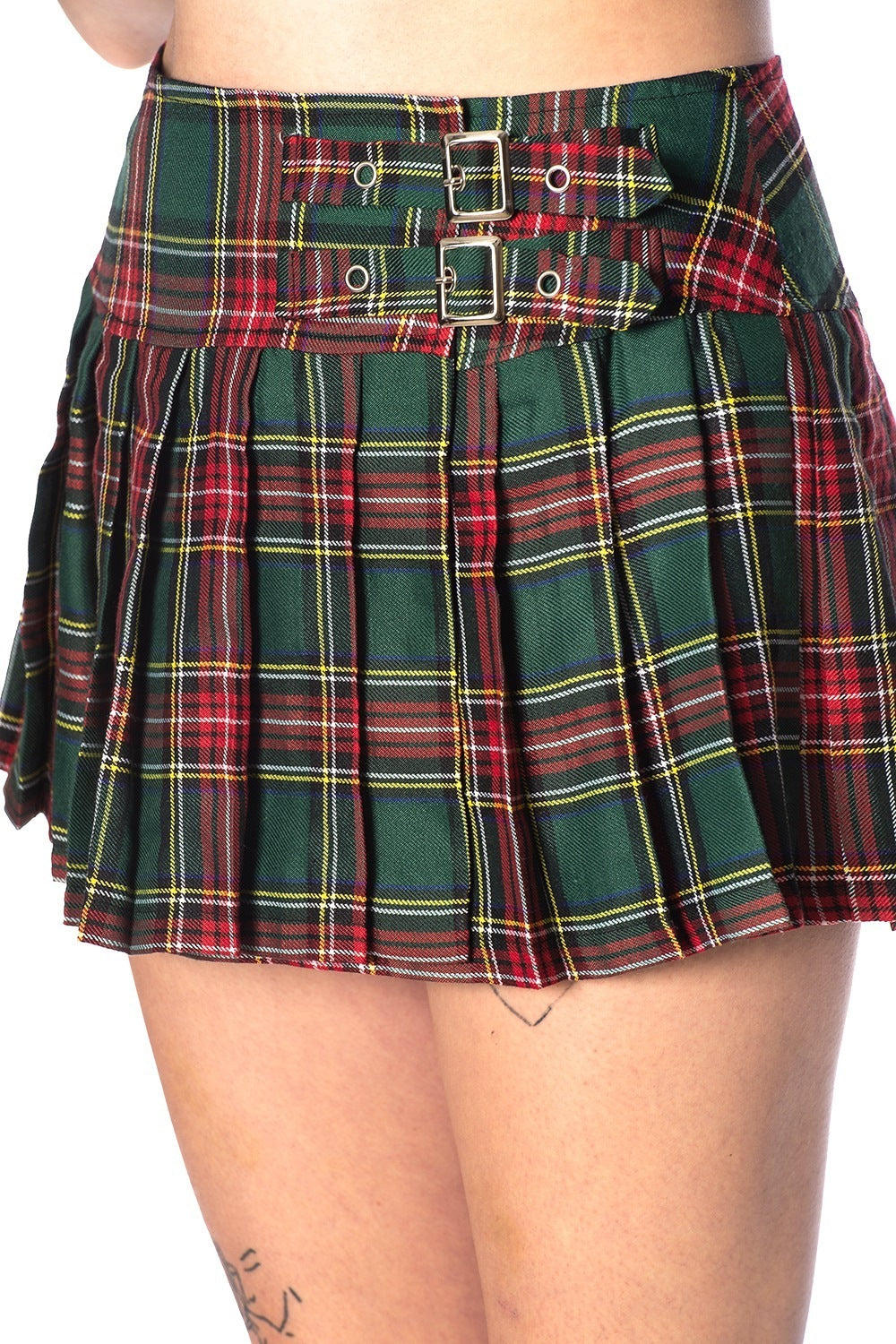 Close up shot of green and red tartan mini skirt with buckle features. 