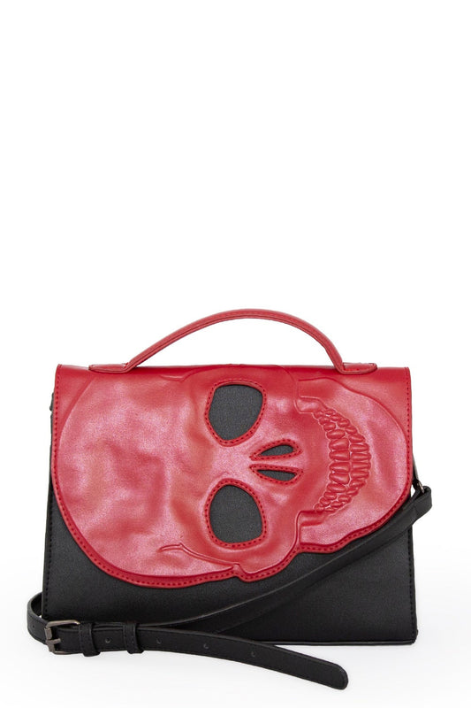 Black handbag with red skull cut out flap with handle strap and long adjustable strap