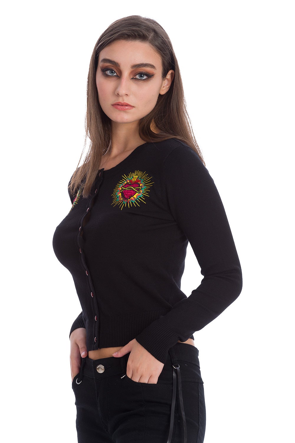 Model wearing black button up cardigan with embroidered red heart on either chest and red buttons.