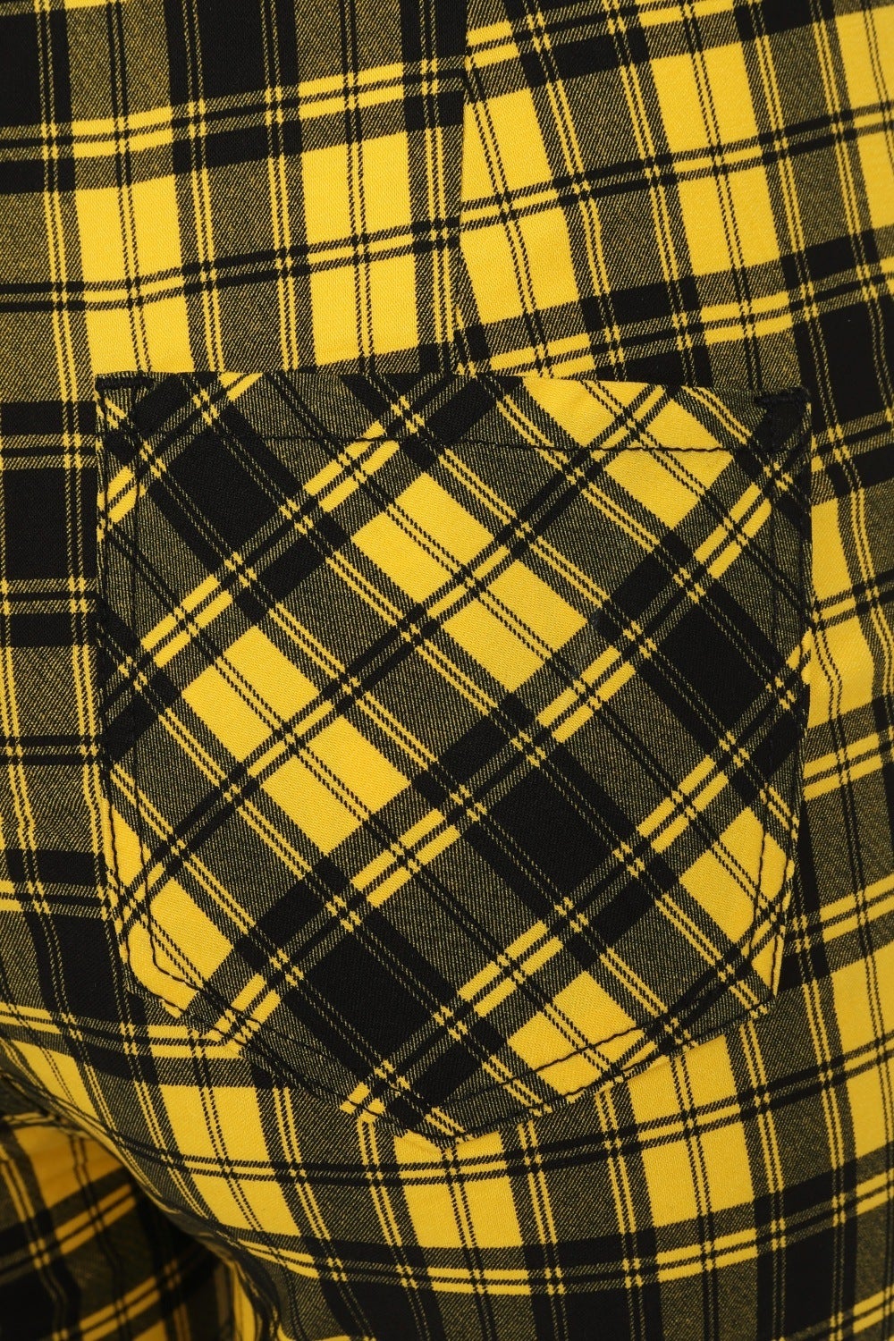 Close up of pocket on back of the yellow check trousers. 