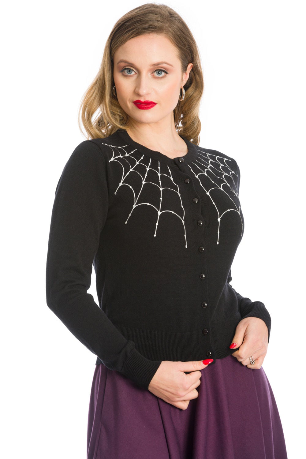 Model in black button up cardigan with white spider web shoulder details 
