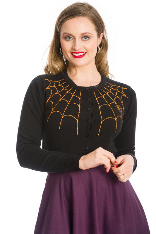 Model in black button up cardigan with orange spider web shoulder details
