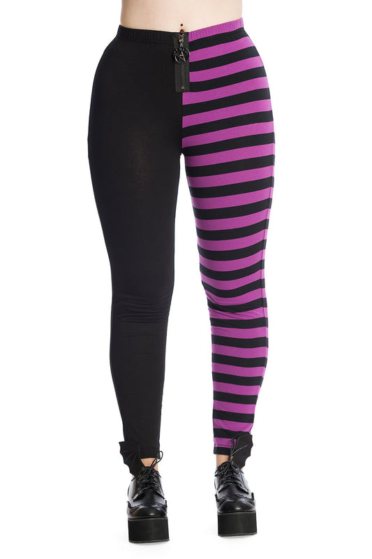 Model wearing high waisted leggings with one black leg and one purple striped leg. Pentagram zip detail.