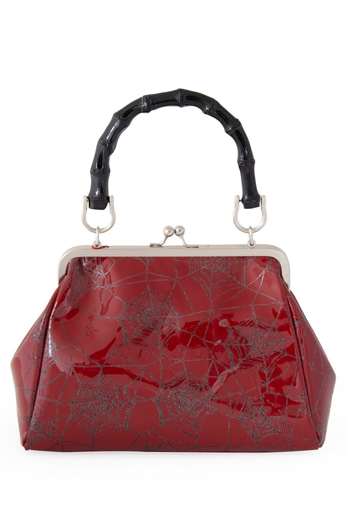 Red patent handbag with spider web print and spider detail 