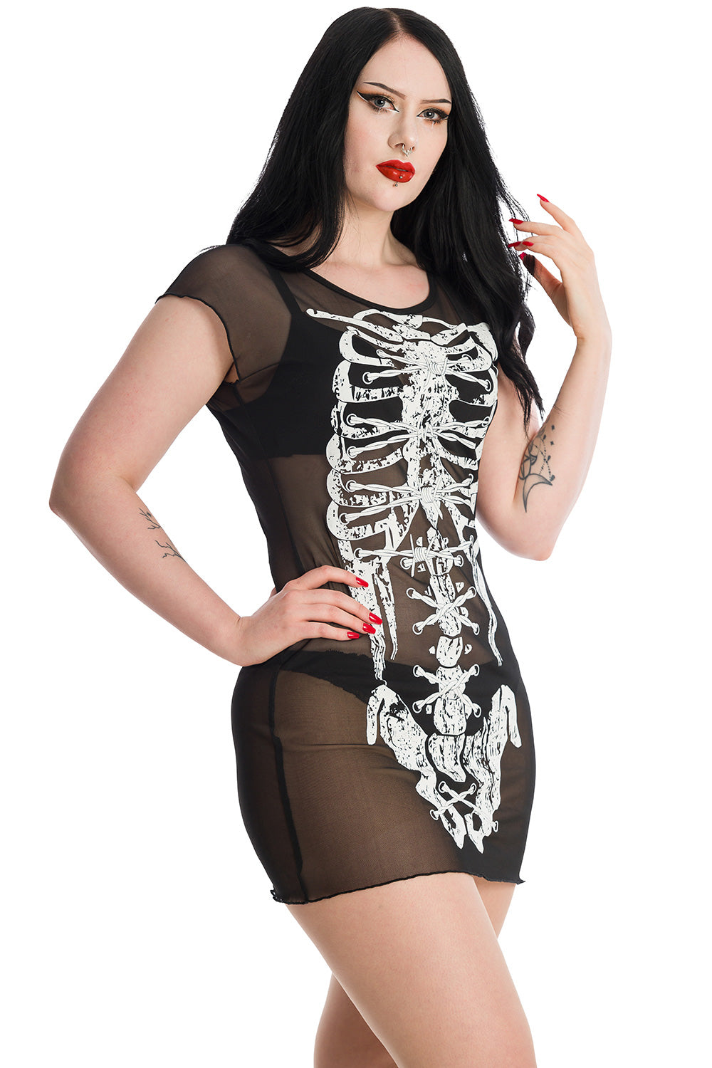 Alternative model wearing black sheer mini dress with white skeleton print. 