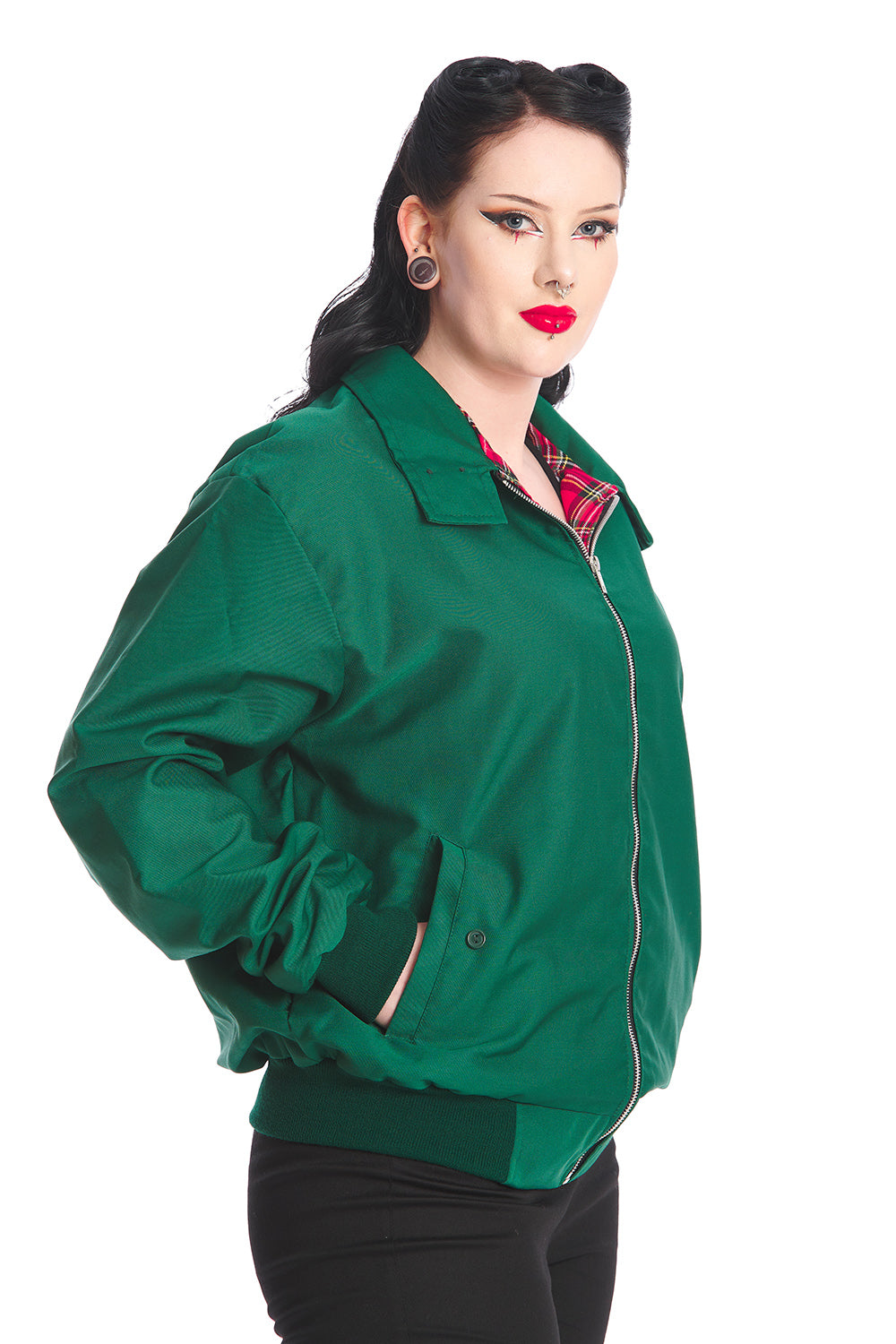 Gothabilly model in a green bomber jacket with red tartan lining.