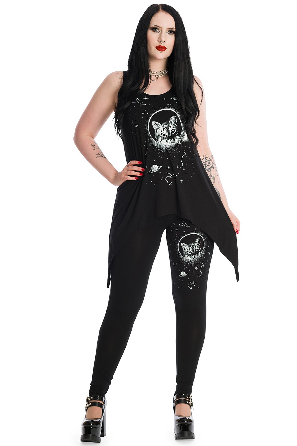 Alternative model wearing long line black vest top with space print and cat feature on the front. Model is wearing matching leggings.