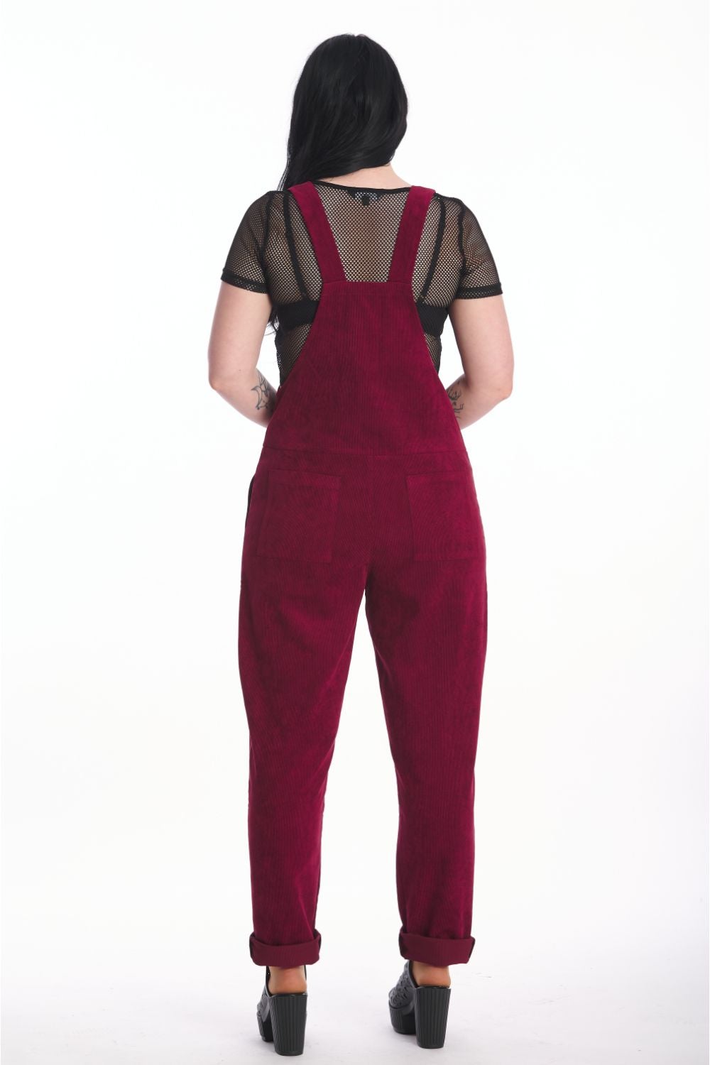 Back of alternative model in moss burgundy dungarees with black mesh crop top underneath. 