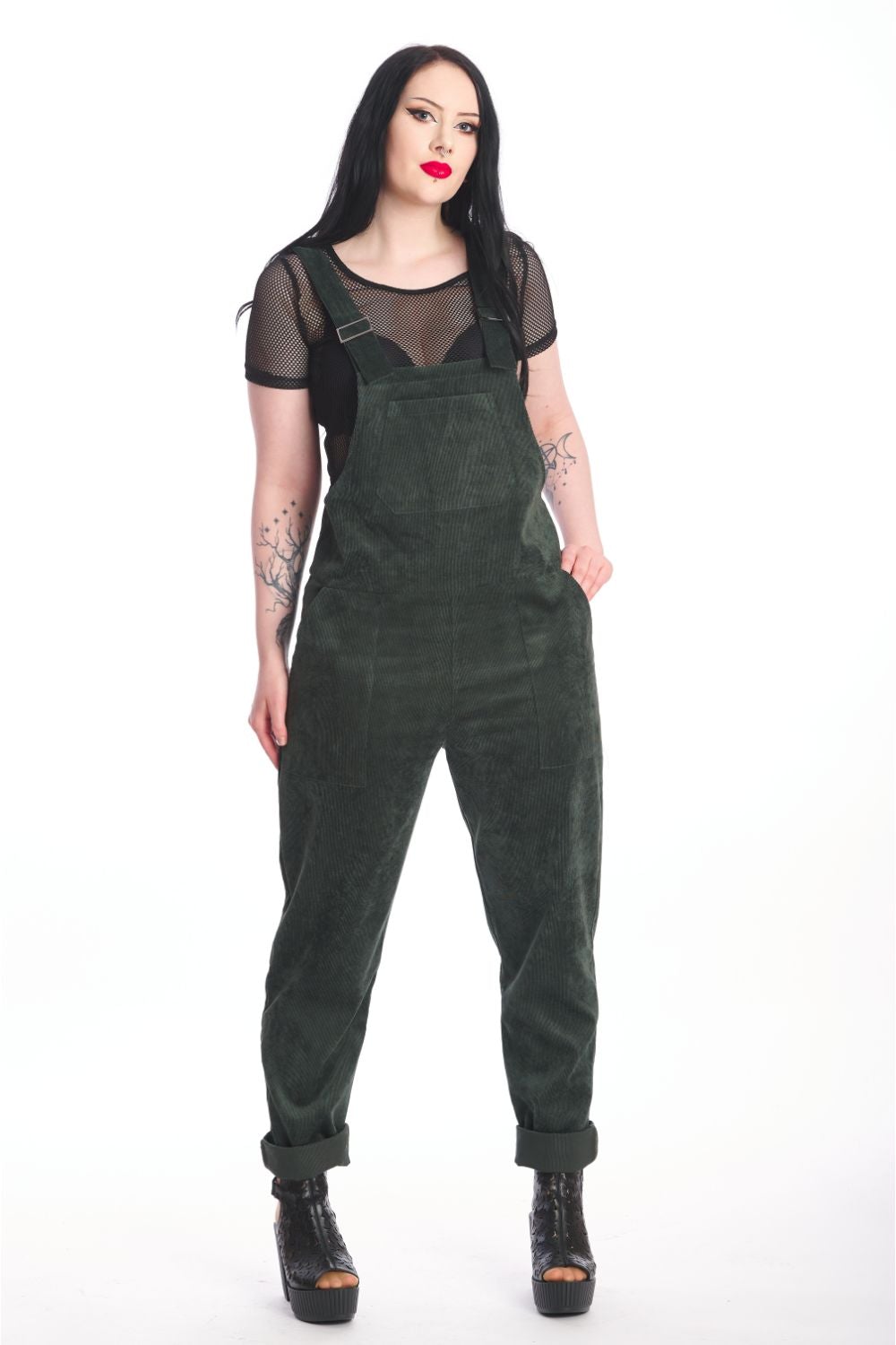 Alternative model in moss green dungarees with black mesh crop top underneath. 