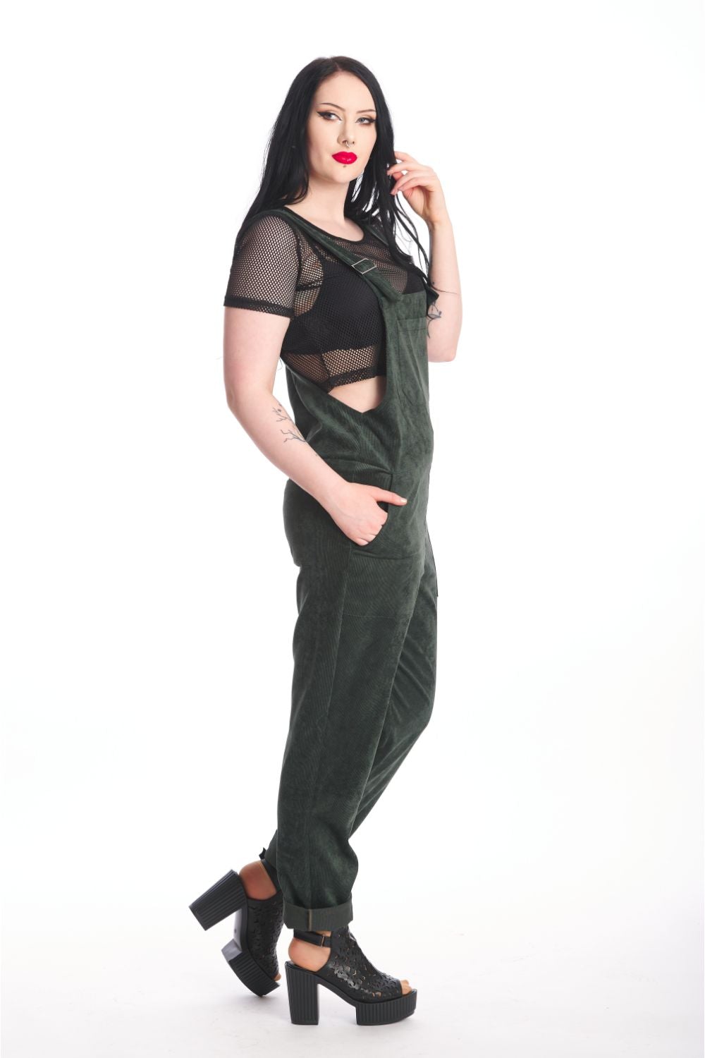 Alternative model in moss green dungarees with black mesh crop top underneath. 