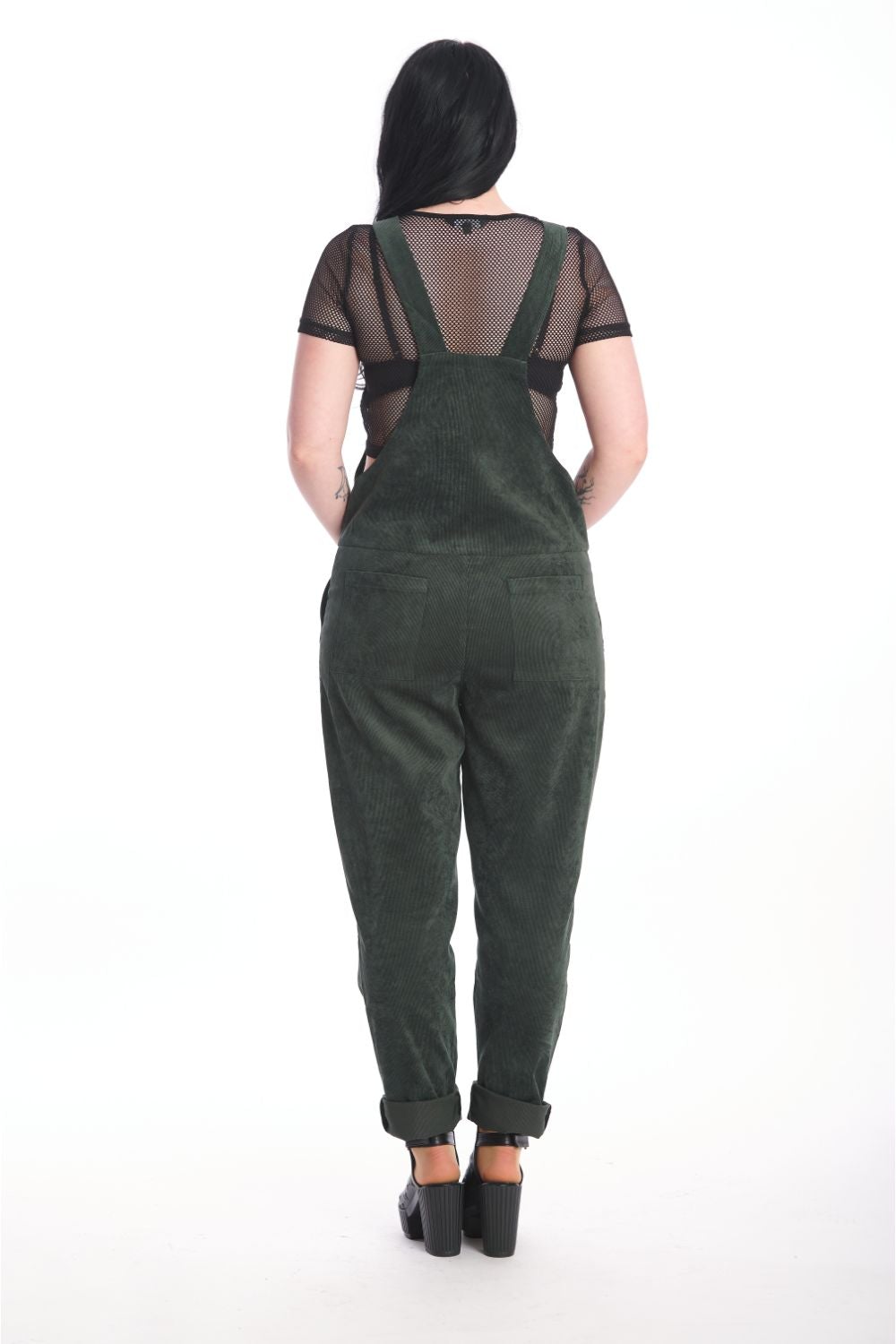 Back of alternative model in moss green dungarees with black mesh crop top underneath. 