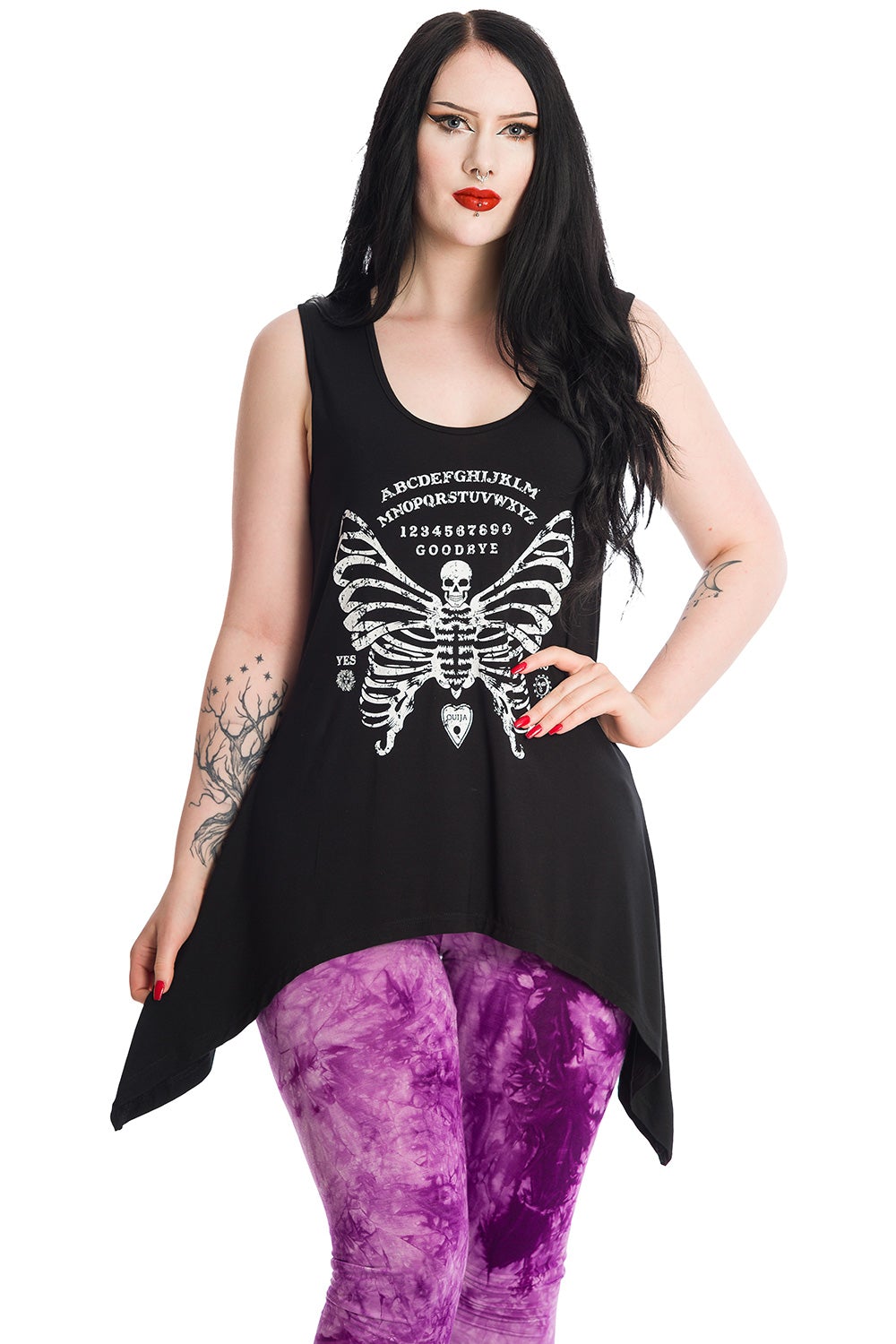 Alternative model wearing long line vest top with skeleton butterfly print with ouija print. 